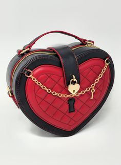 To all Queens out there, this one is for you! Queen of Hearts is a medium sized vampy and edgy heart bag which matches well with many coords, including gothic lolita style and punk alternative outfits. It combines red and black in a tasteful way which gives space to a lovely quilted surface which is soft to the touch, the most adorable heart and key accessories, crown zipper pulls, and easily opens by way of metallic button! The bag is conveniently and simply opened by zipper and has a metallic Red Heart Accessories, Red Heart Purse, Queen Of Hearts Outfit Inspiration, Black And Red Accessories, Heart Purse, Red Clothes, Gothic Bag, Lizzie Hearts, Heart Accessories