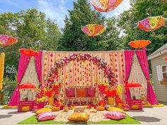 an outdoor wedding setup with umbrellas and decorations