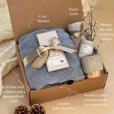 an open box with some items in it that include socks, soaps and candles