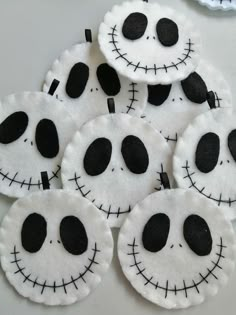 several pieces of felt with black and white designs on them, all in the shape of jack skellingy faces