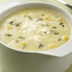 a white bowl filled with soup on top of a table