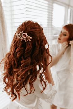 a woman with long red hair wearing a tiara