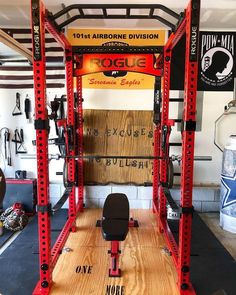 a red and black squat station in a gym