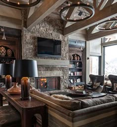 a living room filled with furniture and a flat screen tv mounted on the wall above a fireplace