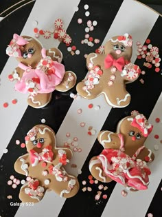 decorated gingerbreads with pink bows on black and white stripes