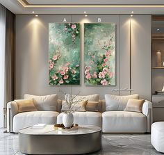 two paintings on the wall in a living room with white couches and coffee table