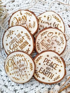 six decorated cookies sitting on top of a white doily with words written on them