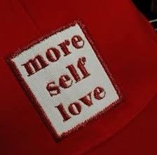 a red hat with the words more self love on it