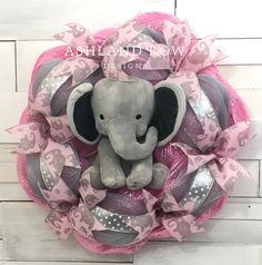 a pink and gray wreath with an elephant on it