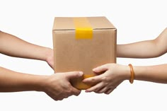 two hands reaching out to each other holding a box in front of white background with copy space