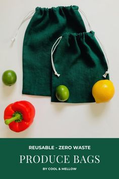 a green bag filled with vegetables next to an orange, pepper, and limes