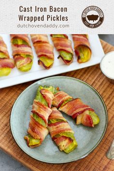 bacon wrapped pickles are on a plate