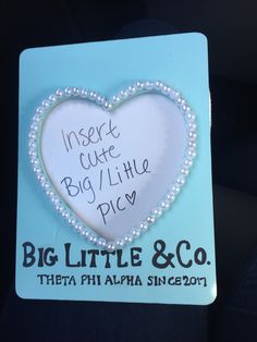 there is a sign that says, insert cute big / little pics with pearls in the shape of a heart