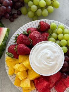 fruit platter with dip surrounded by grapes and watermelon