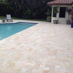 an empty pool with chairs next to it