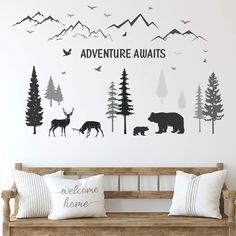 a wall decal with the words adventure awaits and animals