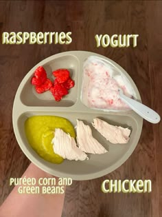 a person holding a plate with different types of food on it, including yogurt, green beans and raspberries