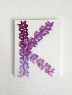 a piece of paper that has been cut into pieces with scissors on the side and purple flowers in the middle