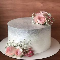 a white cake with pink flowers on top