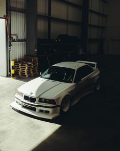 a white car is parked in a garage