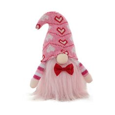 a pink and white knitted gnome with a red bow tie on it's head