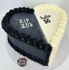 two heart shaped cakes are decorated with black and white frosting, one has the number 20 on it