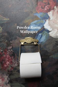 a toilet paper roll holder on top of a wall with flowers in the background and text that reads, powder room wallpaper