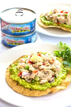 an open can of chicken salad on top of a tortilla with lettuce