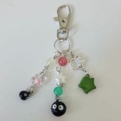 a close up of a key chain with charms attached to it's sides,