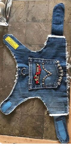 a dog made out of jeans with studded details on the front and back side