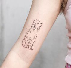 a small dog tattoo on the left inner forearm and wrist, which has a line drawing of a poodle