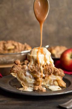 an apple pie is being drizzled with caramel sauce on a plate