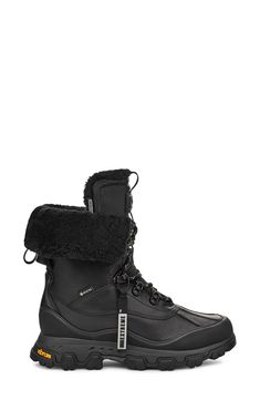 a pair of black boots with fur on the side