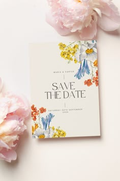 the save the date card is next to some pink peonies and white flowers