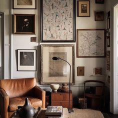 a living room filled with furniture and pictures on the wall