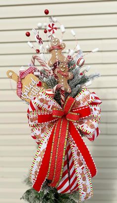 a christmas tree decorated with candy canes and bows