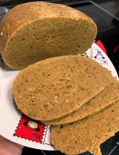 two pieces of bread sitting on top of a white plate next to another piece of bread