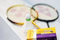 two badminton racquets sitting on top of a table next to a bar of soap