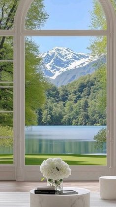 an open window overlooking a lake and mountains