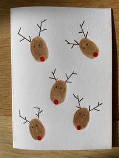 four reindeer's on white paper with red noses