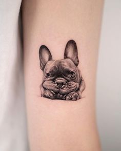 a small tattoo of a french bulldog on the arm