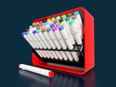 a red pen holder filled with lots of different colored pens next to a white marker