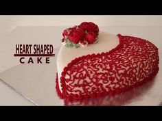 a heart shaped cake with red roses on top and the words, heart shaped cake