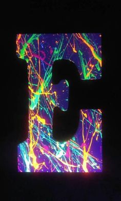 the letter p is lit up with colorful lights in the dark, and it appears to be made out of paper