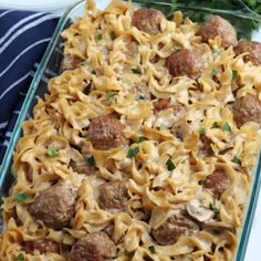 a casserole dish filled with meatballs and noodles