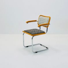 a yellow and black office chair sitting on top of a white floor