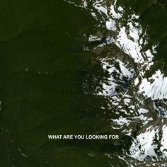 an aerial view of snow covered mountains and the words what are you looking for?