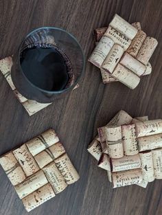 several wine corks and a glass on a table