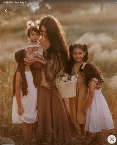 two women and three children standing in a field