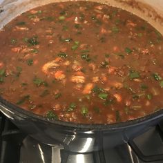 a pot filled with soup sitting on top of a stove